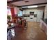 Kitchen features white cabinets, tile floors and an island at 855 Pinewood W Ter, Palm Harbor, FL 34683