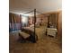 Spacious main bedroom with king-size bed and ensuite bathroom at 855 Pinewood W Ter, Palm Harbor, FL 34683