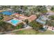 Aerial view of Highland Lakes community clubhouse, pool, and tennis courts at 1120 Tartan Dr, Palm Harbor, FL 34684