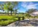 Landscaped backyard with pavers and golf course view at 1120 Tartan Dr, Palm Harbor, FL 34684