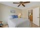 Cozy guest bedroom with a queen-size bed and access to another room at 1120 Tartan Dr, Palm Harbor, FL 34684