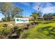 Highland Lakes Club entrance with landscaping and flag at 1120 Tartan Dr, Palm Harbor, FL 34684