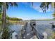 Wooden dock extending to a serene lake at 1120 Tartan Dr, Palm Harbor, FL 34684