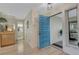 Light and airy entryway with light wood floors and a blue door at 1120 Tartan Dr, Palm Harbor, FL 34684