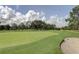 Scenic golf course with lush greens and mature trees at 1120 Tartan Dr, Palm Harbor, FL 34684