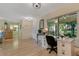 Living room features a desk and views of the covered patio at 1120 Tartan Dr, Palm Harbor, FL 34684