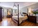 Main bedroom with hardwood floors, a four poster bed, and plenty of light at 4202 W Culbreath Ave, Tampa, FL 33609