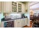 Butler's pantry offers ample storage, granite countertops, and a wine chiller at 4202 W Culbreath Ave, Tampa, FL 33609