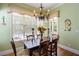 Bright dining room with charming window treatments and hardwood floors at 4202 W Culbreath Ave, Tampa, FL 33609