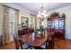 Bright dining room featuring a large wood table, buffet, and china cabinet at 4202 W Culbreath Ave, Tampa, FL 33609