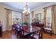 Elegant formal dining room with hardwood floors, large windows, and a beautiful chandelier at 4202 W Culbreath Ave, Tampa, FL 33609