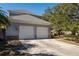 Two-car garage with white doors and stone accents at 4202 W Culbreath Ave, Tampa, FL 33609