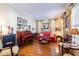 Living room features hardwood floors, red sofa and piano at 4202 W Culbreath Ave, Tampa, FL 33609