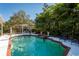 Relaxing pool area with pergola, outdoor kitchen, and ample seating at 4202 W Culbreath Ave, Tampa, FL 33609