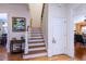 Elegant hardwood staircase with white railings and adjacent storage closet at 4202 W Culbreath Ave, Tampa, FL 33609