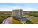 Aerial view of a luxurious condo building with a pool and pond at 10851 Mangrove Cay Ne Ln # 1112, St Petersburg, FL 33716