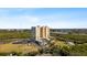 Aerial view showcasing condo building, landscape, and water features at 10851 Mangrove Cay Ne Ln # 1112, St Petersburg, FL 33716