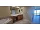 Bathroom with soaking tub, vanity and view to bedroom at 10851 Mangrove Cay Ne Ln # 1112, St Petersburg, FL 33716