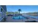 Community pool with water view and lounge chairs at 10851 Mangrove Cay Ne Ln # 1112, St Petersburg, FL 33716