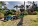 Landscaped backyard with a shed and various plants in pots at 1747 Douglas Ave, Dunedin, FL 34698