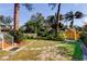 Landscaped backyard with shed and tiled pathway at 1747 Douglas Ave, Dunedin, FL 34698