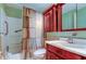 Bathroom with wood vanity and shower/tub combo at 1747 Douglas Ave, Dunedin, FL 34698