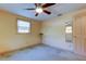 Simple bedroom with carpet flooring and ceiling fan at 1747 Douglas Ave, Dunedin, FL 34698