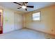 Simple bedroom with carpet flooring and ceiling fan at 1747 Douglas Ave, Dunedin, FL 34698