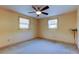 Simple bedroom with carpet flooring and ceiling fan at 1747 Douglas Ave, Dunedin, FL 34698