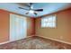 Simple bedroom with carpet flooring and ceiling fan at 1747 Douglas Ave, Dunedin, FL 34698