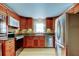 Kitchen with stainless steel appliances and wood cabinets at 1747 Douglas Ave, Dunedin, FL 34698