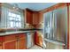 Kitchen with stainless steel appliances and wood cabinets at 1747 Douglas Ave, Dunedin, FL 34698