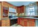 Kitchen featuring wood cabinets and stainless steel appliances at 1747 Douglas Ave, Dunedin, FL 34698