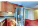 Kitchen boasts stainless steel refrigerator and wood cabinets at 1747 Douglas Ave, Dunedin, FL 34698