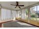 Bright and airy sunroom with multiple windows and a ceiling fan at 1747 Douglas Ave, Dunedin, FL 34698