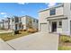 Two-story townhome with attached garage and landscaped front yard at 33055 Tulip Petal Ln, Wesley Chapel, FL 33545