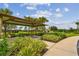 Covered picnic table with lush landscaping and walkway at 33055 Tulip Petal Ln, Wesley Chapel, FL 33545