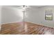 Bright bedroom featuring wood-look floors and ceiling fan at 3722 Village Estates Pl, Tampa, FL 33618