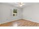 Bedroom featuring wood-look floors, white walls, and window shutters at 3722 Village Estates Pl, Tampa, FL 33618