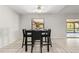 Dining area with black table and four chairs, near kitchen at 3722 Village Estates Pl, Tampa, FL 33618