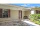 House entrance with a wood door and decorative bench at 3722 Village Estates Pl, Tampa, FL 33618