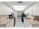 Galley kitchen with white cabinets and black appliances at 3722 Village Estates Pl, Tampa, FL 33618