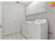 Laundry room with washer, dryer, and cabinets at 3722 Village Estates Pl, Tampa, FL 33618