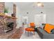 Living room with brick fireplace and wood floors at 3722 Village Estates Pl, Tampa, FL 33618