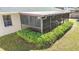 Screened patio area with brown tile flooring at 3722 Village Estates Pl, Tampa, FL 33618