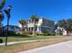 Two story house with balconies, lush landscaping, and a fenced pool area at 6519 Simone Shores Cir, Apollo Beach, FL 33572