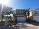 Front view of two-story house with gray facade, white garage door, and landscaping at 6519 Simone Shores Cir, Apollo Beach, FL 33572