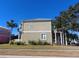 Side view of a two-story house, gray siding, white trim, and landscaping at 6519 Simone Shores Cir, Apollo Beach, FL 33572