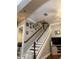 Staircase with white risers, wooden handrail, and Gathering photos on the wall at 6519 Simone Shores Cir, Apollo Beach, FL 33572