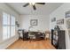 Home office with built-in shelving and hardwood floors at 9719 Pleasant Run Way, Tampa, FL 33647